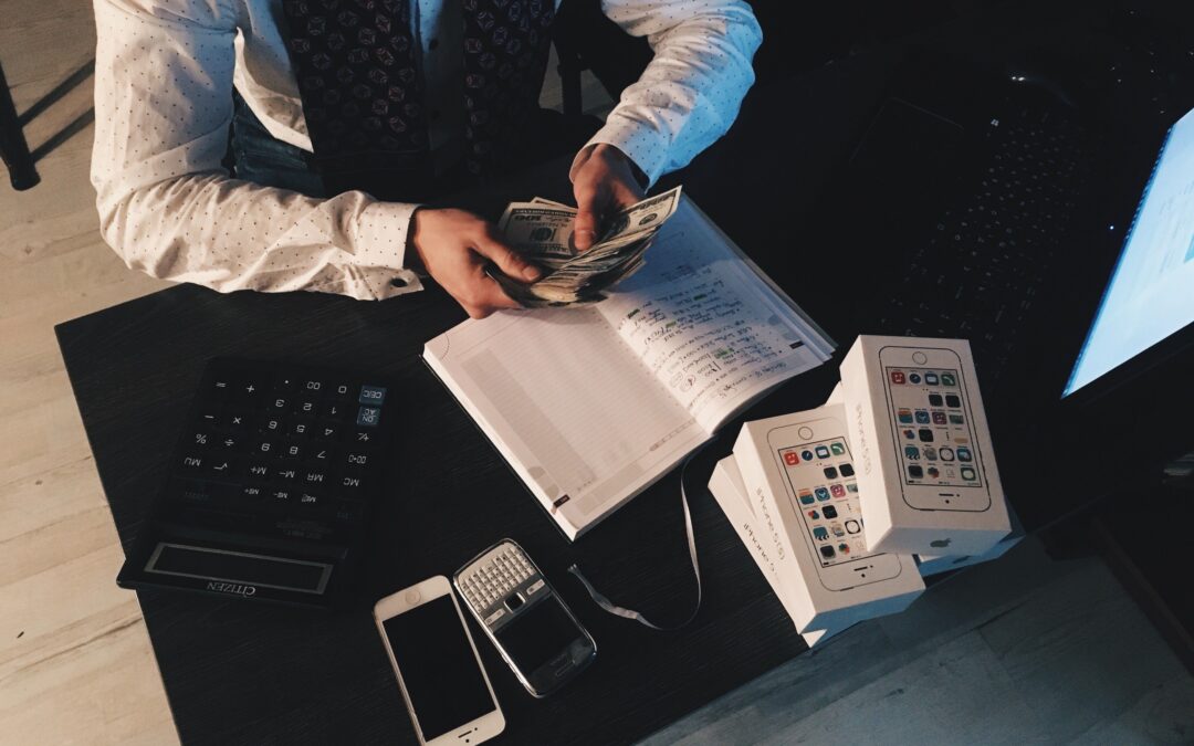 Sole trader using a tax calculator on a laptop to estimate Income Tax and National Insurance for 2026/27